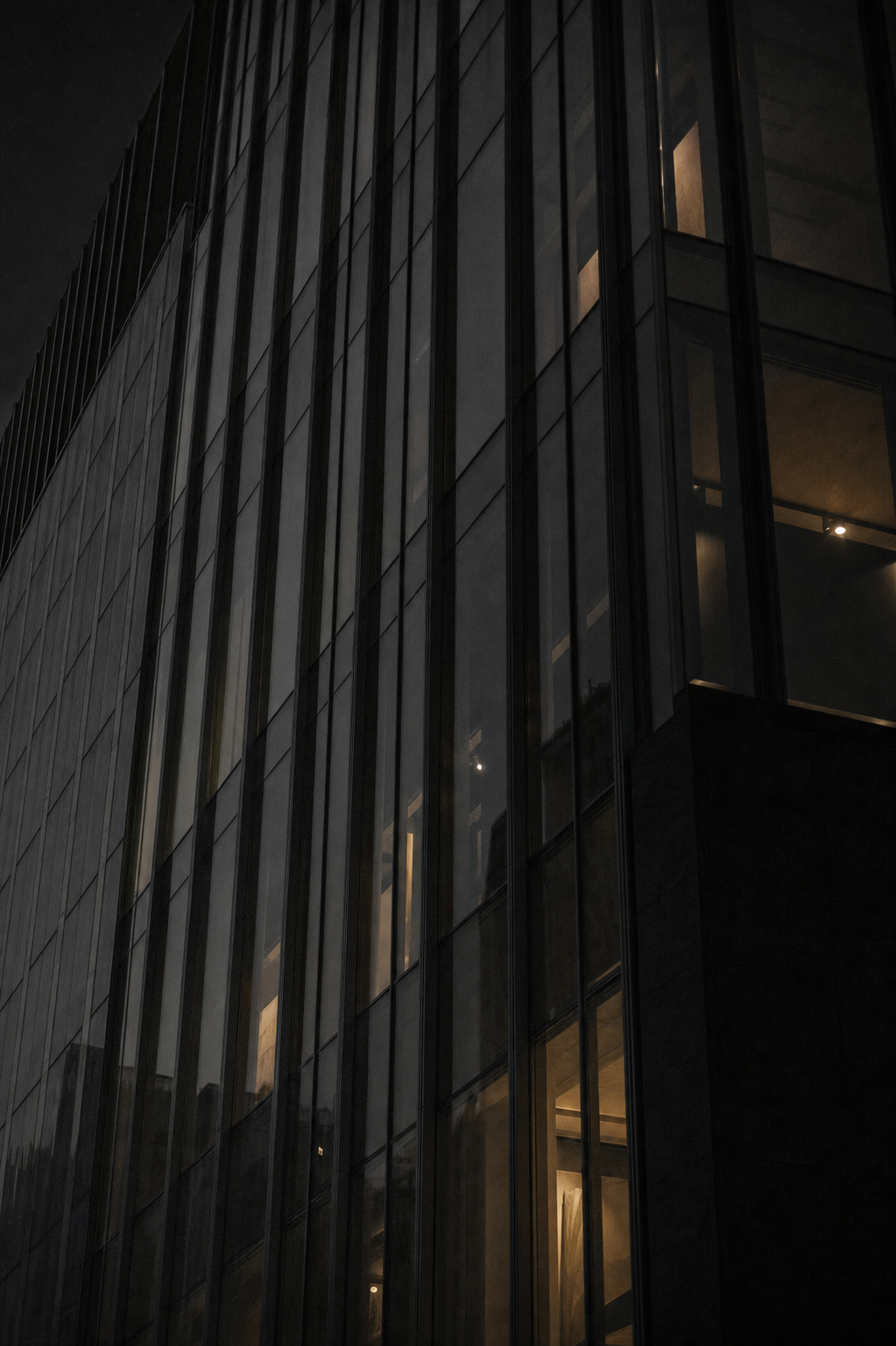 Institutional glass-and-steel facade at dusk